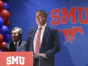 New SMU head NCAA college football coach Sonny Dykes, right, laughs with university president Gerald Turner after Dykes introduction in Dallas, Tuesday, Dec. 12, 2017. SMU hired the former California and Louisiana Tech coach as its new coach, replacing one Texan with reputation for directing potent offenses for another. Dykes will replace Chad Morris, who left SMU last week to become Arkansas' coach.