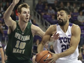 TCU guard Alex Robinson (25) drives against William & Mary guard Connor Burchfield (10) during the first half of an NCAA college basketball game in Fort Worth, Texas, Friday, Dec. 22, 2017.
