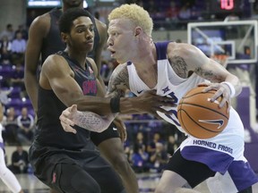 TCU guard Jaylen Fisher (0) drives against SMU guard Jimmy Whitt during the first half of an NCAA college basketball game in Fort Worth, Texas, Tuesday, Dec. 5, 2017.