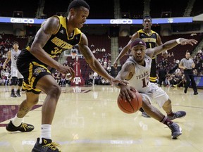 Texas A&M guard Duane Wilson (13) dives for a loose ball as Northern Kentucky guard Lavone Holland II (30) reaches in during the first half of an NCAA college basketball game Tuesday, Dec. 19, 2017, in College Station, Texas.