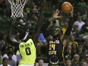 Wichita State center Shaquille Morris, right, attempts a shot over Baylor forward Jo Lual-Acuil Jr., left, in the first half of an NCAA college basketball game, Saturday, Dec. 2, 2017, in Waco, Texas.