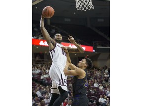 Texas A&M center Tonny Trocha-Morelos (10) goes up for a dunk against Prairie View A&M guard Austin Starr (30) during the first half of an NCAA college basketball game Saturday, Dec. 9, 2017, in College Station, Texas.