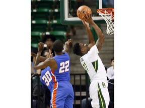 Savannah State's Jahir Cabeza (30) and Dexter McClanahan (22) defend as Baylor's Mark Vital (11) goes up for a shot in the first half of an NCAA college basketball game, Sunday, Dec. 17, 2017, in Waco, Texas.