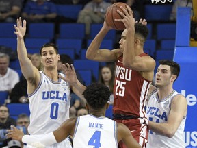 Washington State forward Arinze Chidom (25) looks to pass while being defended by UCLA's Alex Olesinski (0), Jaylen Hands (4) and Gyorgy Goloman, right, during the first half of an NCAA college basketball game Friday, Dec. 29, 2017, in Los Angeles.