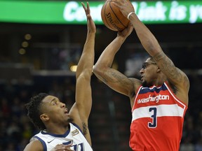 Washington Wizards guard Bradley Beal (3) attempts to pass over Utah Jazz guard Donovan Mitchell (45) in the first half during of an NBA basketball game Monday, Dec. 4, 2017, in Salt Lake City.