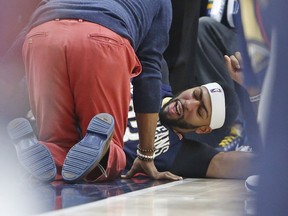 New Orleans Pelicans forward Anthony Davis lies on the court after being injured in the second half during an NBA basketball game against the Utah Jazz, Friday, Dec. 1, 2017, in Salt Lake City.