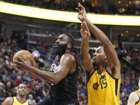 Houston Rockets guard James Harden, left, goes to the basket as Utah Jazz forward Derrick Favors (15) defends during the first half of an NBA basketball game Thursday, Dec. 7, 2017, in Salt Lake City.