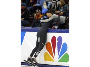Lana Gehring (2) celebrates with coach Linlin Sun after winning the women's 1000-meter A final race during the U.S. Olympic short track speedskating trials Sunday, Dec. 17, 2017, in Kearns, Utah.