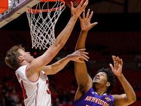 Utah forward Jayce Johnson (34) shoots as Northwestern State center Larry Owens (42) defends during an NCAA college basketball game in Salt Lake City, Wednesday, Dec, 20, 2017.