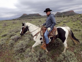 FILE - In this May 9, 2017, file photo, Interior Secretary Ryan Zinke rides a horse in the new Bears Ears National Monument near Blanding, Utah. Utah has long stood out for going far beyond other Western states in trying to get back control of its federally protected lands. When President Donald Trump on Monday, Dec. 4, 2017, announces he's going to shrink two national monuments in the state, his warm welcome will stand out in a region that is normally protective of its parks and monuments.