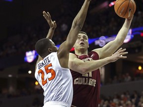 Boston College's Nik Popovic (21) shoots over Virginia's Mamadi Diakite (25) in the first half of an NCAA college basketball game Saturday, Dec. 30, 2017, in Charlottesville, Va.