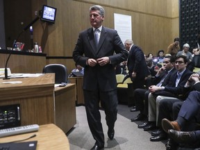 Former U.S. Attorney Tim Heaphy walks to the podium to present findings of an investigation about the Aug. 12 "Unite the Right" rally to the Charlottesville city council on Monday, Dec. 4, 2017. The Charlottesville City Council is meeting for the first time since the former federal prosecutor released a report sharply critical of the government and law enforcement response to a white nationalist rally this summer.