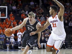 Davidson's Peyton Aldridge (23) drives past Virginia's Isaiah Wilkins (21) in the first half of an NCAA college basketball game on Saturday, Dec. 16, 2017, in Charlottesville, Va.