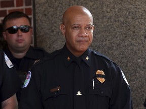 FILE - In a Wednesday, Aug. 16, 2017 file photo, Charlottesville Police Chief Al S. Thomas Jr. exits the memorial service for Heather Heyer, at the Paramount Theater in Charlottesville, Va. Heyer was killed when a car rammed into a crowd of people protesting a white nationalist rally. Thomas Jr., who was criticized over the department's response to the violent white nationalist rally this summer, announced his retirement Monday, Dec. 18, 2017, effective immediately.