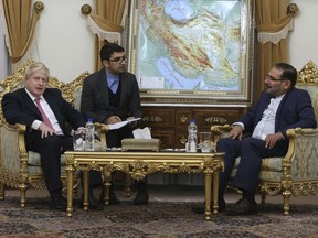British Foreign Secretary Boris Johnson, left, and Secretary of Iran's Supreme National Security Council Ali Shamkhani, right, with interpreter at centre, during their meeting in Tehran, Iran, Saturday, Dec. 9, 2017.   Johnson arrived in Tehran Saturday, where he is expected to discuss the fate of detained British-Iranian woman Nazanin Zaghari-Ratcliffe, who is serving a five-year prison sentence for allegedly plotting to overthrow Iran's government.