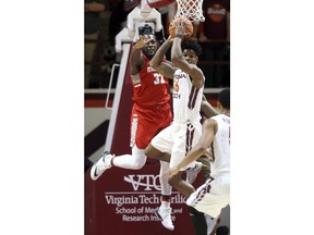 Virginia Tech's Ahmed Hill (13) grabs a defensive rebound in front of Radford's Randy Phillips (32) in the first half of an NCAA college basketball game in Blacksburg, Va., Wednesday, Dec. 6 2017.