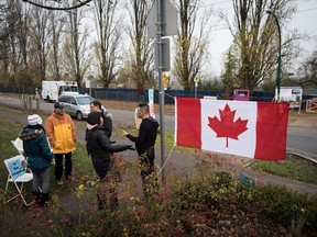 Protesting residents gather across the street from the site where temporary modular housing will be constructed to house homeless people, in Vancouver, B.C., on Thursday December 7, 2017. The City of Vancouver was granted an injunction earlier this week from the Supreme Court of B.C. against protesters who were preventing work crews from accessing the site in the neighbourhood of Marpole.