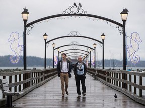 A pigeon flies past Prime Minister Justin Trudeau, left, as he and South Surrey-White Rock Liberal byelection candidate Gordie Hogg walk along the pier in White Rock, B.C., on Saturday, December 2, 2017. A federal byelection will be held Dec. 11 for the seat vacated by former Conservative MP Dianne Watts, who stepped down to run for the leadership of the B.C. Liberal Party.
