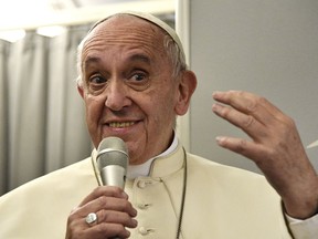 Pope Francis talks during a news conference on board a flight to return to Rome, Saturday Dec. 2, 2017, after a seven day trip to Myanmar and Bangladesh. Pope Francis urged Bangladeshi priests and nuns to resist the "terrorism of gossip" that can tear religious communities apart, delivering one of his trademark, zinger-filled spontaneous speeches to the country's Catholic leadership on Saturday at the close of an otherwise tense and diplomatically fraught Asian tour.