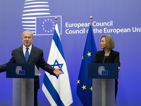 European Union High Representative Federica Mogherini, right, and Israeli Prime Minister Benjamin Netanyahu address a media conference at the EU Council building in Brussels on Monday, Dec. 11, 2017.