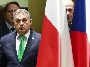 Hungarian Prime Minister Viktor Orban, left, arrives for a meeting of the Visegrad Group on the sidelines of an EU summit in Brussels on Thursday, Dec. 14, 2017. European Union leaders are gathering in Brussels and are set to move Brexit talks into a new phase as pressure mounts on Prime Minister Theresa May over her plans to take Britain out of the 28-nation bloc.