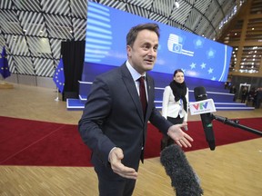 Luxembourg's Prime Minister Xavier Bettel speaks with journalists as he arrives for an EU summit at the Europa building in Brussels on Thursday, Dec. 14, 2017. European Union leaders are gathering in Brussels and are set to move Brexit talks into a new phase as pressure mounts on Prime Minister Theresa May over her plans to take Britain out of the 28-nation bloc.