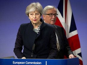 European Commission President Jean-Claude Juncker, right, walks behind British Prime Minister Theresa May prior to addressing a media conference at EU headquarters in Brussels on Monday, Dec. 4, 2017. British Prime Minister Theresa May and EU Commission President Jean-Claude Juncker held a power lunch on Monday, seeking a breakthrough in the Brexit negotiations ahead of a key EU summit the week after.