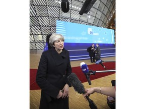 British Prime Minister Theresa May speaks with the media as she arrives for an EU summit at the Europa building in Brussels on Thursday, Dec. 14, 2017. European Union leaders are gathering in Brussels and are set to move Brexit talks into a new phase as pressure mounts on Prime Minister Theresa May over her plans to take Britain out of the 28-nation bloc.