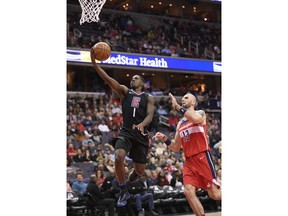 Los Angeles Clippers guard Jawun Evans (1) goes to the basket past Washington Wizards center Marcin Gortat (13), of Poland, during the first half of an NBA basketball game, Friday, Dec. 15, 2017, in Washington.