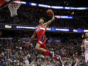 Washington Wizards forward Kelly Oubre Jr. (12) goes for a dunk past Houston Rockets forward Ryan Anderson (33) during the second half of an NBA basketball game Friday, Dec. 29, 2017, in Washington. The Wizards won 121-103.