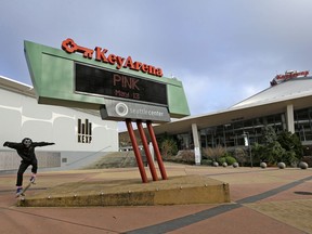 A skateboarder leaps onto a platform in front of KeyArena, a sports and entertainment venue at the Seattle Center, Monday, Dec. 4, 2017, in Seattle. The Seattle City Council on Monday approved a memorandum of understanding with Los Angeles-based Oak View Group in a $600 million privately financed project to renovate the facility, formerly the home of the NBA's SuperSonics.