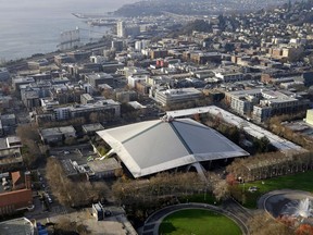 The iconic sloped roof of KeyArena, center, a sports and entertainment venue at the Seattle Center, is seen from above Monday, Dec. 4, 2017, in Seattle. The Seattle City Council on Monday approved a memorandum of understanding with Los Angeles-based Oak View Group in a $600 million privately financed project to renovate the facility, formerly the home of the NBA's SuperSonics.