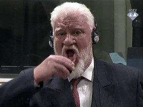 In this Wednesday, Nov. 29, 2017 file image taken from video, Slobodan Praljak brings a bottle to his lips, during a Yugoslav War Crimes Tribunal in The Hague, Netherlands.