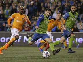 Seattle Sounders midfielder Victor Rodriguez, center, kicks a goal against the Houston Dynamo during the first half of the second leg of the MLS soccer Western Conference final, Thursday, Nov. 30, 2017, in Seattle. (AP Photo/Ted S. Warren)