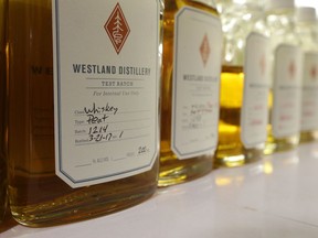 In this Nov. 14, 2017 photo, a test batch of peated whiskey is stored in a bottle in the blending room of the Westland Distillery in Seattle. Westland is taking an unusual step for America's booming spirits industry: making a whiskey using smoke from peat grown locally in Washington state.