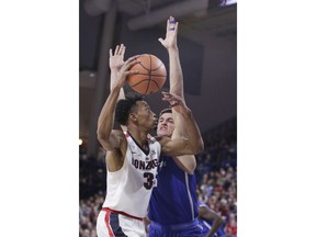 Gonzaga forward Johnathan Williams (3) drives to the basket against Creighton forward Martin Krampelj during the first half of an NCAA college basketball game in Spokane, Wash., Friday, Dec. 1, 2017.