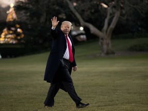 President Donald Trump waves as he walks on the South Lawn upon his return to the White House in Washington, Thursday, Dec. 21, 2017, from a visit to Walter Reed National Military Medical Center in Bethesda, Md.