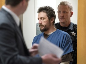 FILE - In this Oct. 19, 2017 file photo, Joseph Jakubowski is escorted into a courtroom at the Rock County Courthouse in Janesville, Wis. Jakubowski, who stole a cache of firearms from a gun shop and sent a rambling anti-government manifesto to President Donald Trump before going on the run, faces up to 20 years in federal prison when he is sentenced Wednesday, Dec. 20, 2017.