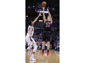 Chicago Bulls' Lauri Markkanen shoots over Milwaukee Bucks' Giannis Antetokounmpo during the first half of an NBA basketball game, Tuesday, Dec. 26, 2017, in Milwaukee.