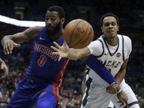 Detroit Pistons' Andre Drummond and Milwaukee Bucks' John Henson go after a loose ball during the first half of an NBA basketball game Wednesday, Dec. 6, 2017, in Milwaukee.