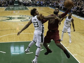 Cleveland Cavaliers' LeBron James shoots past Milwaukee Bucks' Sterling Brown during the first half of an NBA basketball game Tuesday, Dec. 19, 2017, in Milwaukee.