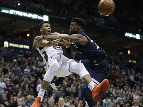 Milwaukee Bucks' Giannis Antetokounmpo is fouled by Minnesota Timberwolves' Jimmy Butler during the second half of an NBA basketball game Thursday, Dec. 28, 2017, in Milwaukee. The Bucks won 102-96.