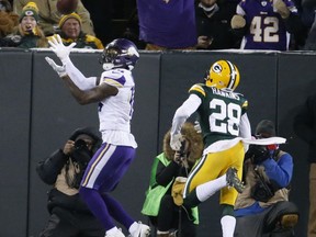 Minnesota Vikings' Stefon Diggs catches a touchdown pass in front of Green Bay Packers' Josh Hawkins during the first half of an NFL football game Saturday, Dec. 23, 2017, in Green Bay, Wis.