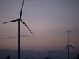Wind turbines stand at the Subplu wind farm at dusk in Huay Bong, Thailand. MUST CREDIT: Bloomberg photo by Brent Lewin