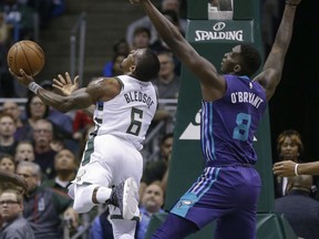 Milwaukee Bucks' Eric Bledsoe puts up a shot against Charlotte Hornets' Johnny O'Bryant III during the first half of an NBA basketball game Friday, Dec. 22, 2017, in Milwaukee.