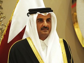 Qatar's emir, Sheikh Tamim bin Hamad Al Thani, stands for a group photograph at the Gulf Cooperation Council summit in Kuwait City, Tuesday, Dec. 5, 2017. Kuwait hosted a meeting Tuesday of the Gulf Cooperation Council that saw Qatar's ruling emir attend, but other rulers stayed away amid the ongoing boycott targeting Doha.