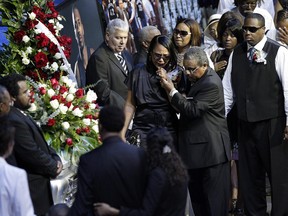 FILE - In this Aug. 4, 2010, file photo, Sherra Wright, the ex-wife of slain NBA basketball player Lorenzen Wright, grieves at the casket of Lorenzen Wright during a memorial service at the FedExForum in Memphis, Tenn. Authorities said Saturday, Dec 16, 2017, that Sherra Wright was charged with first-degree murder in the death of her ex-husband. (AP Photo/Lance Murphey, File) ORG XMIT: NYAG601