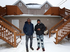 Seidu Mohammed (left) and Razak Iyal pose for a photograph in the backyard of Iyal's apartment in Winnipeg on Wed., Dec. 20, 2017.
