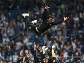 In this Sunday, Dec. 10, 2017 photo, Tigres' soccer player Damian Alvarez is thrown into the air during celebrations after his team's victory over Monterrey and clenching of the Mexican soccer league championship title in Monterrey, Mexico.