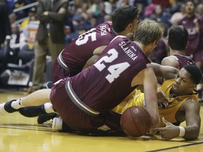 West Virginia forward Sagaba Konate (50) wrestles for control of a loose ball during the first half of an NCAA college basketball game against Fordham Saturday, Dec. 23, 2017, in Morgantown, W.Va.